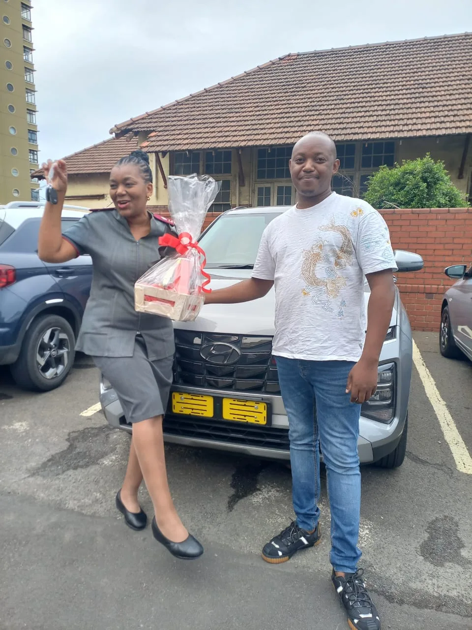A customer collecting the keys to her new silver Hyundai Creta from The CarspotterSA.