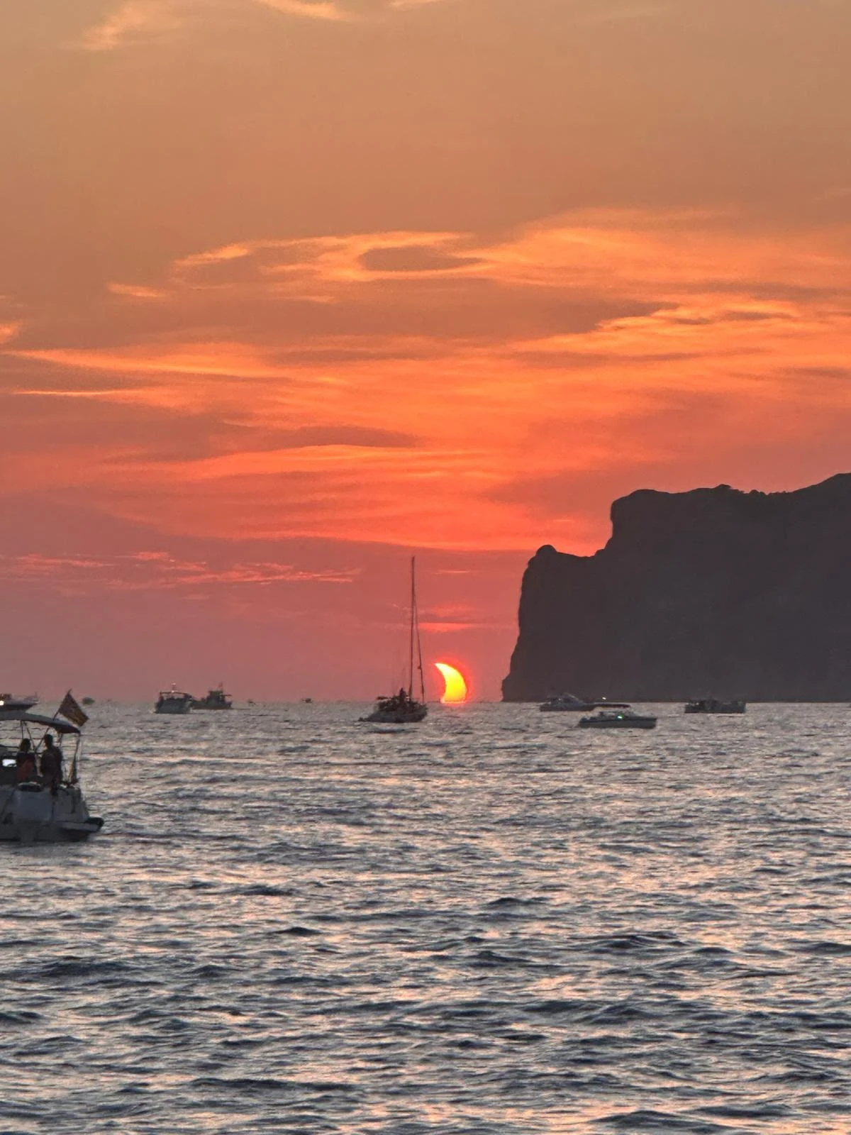 A sailboat silhouetted against the setting sun off Mallorca's coast — the island light that has drawn painters here for centuries