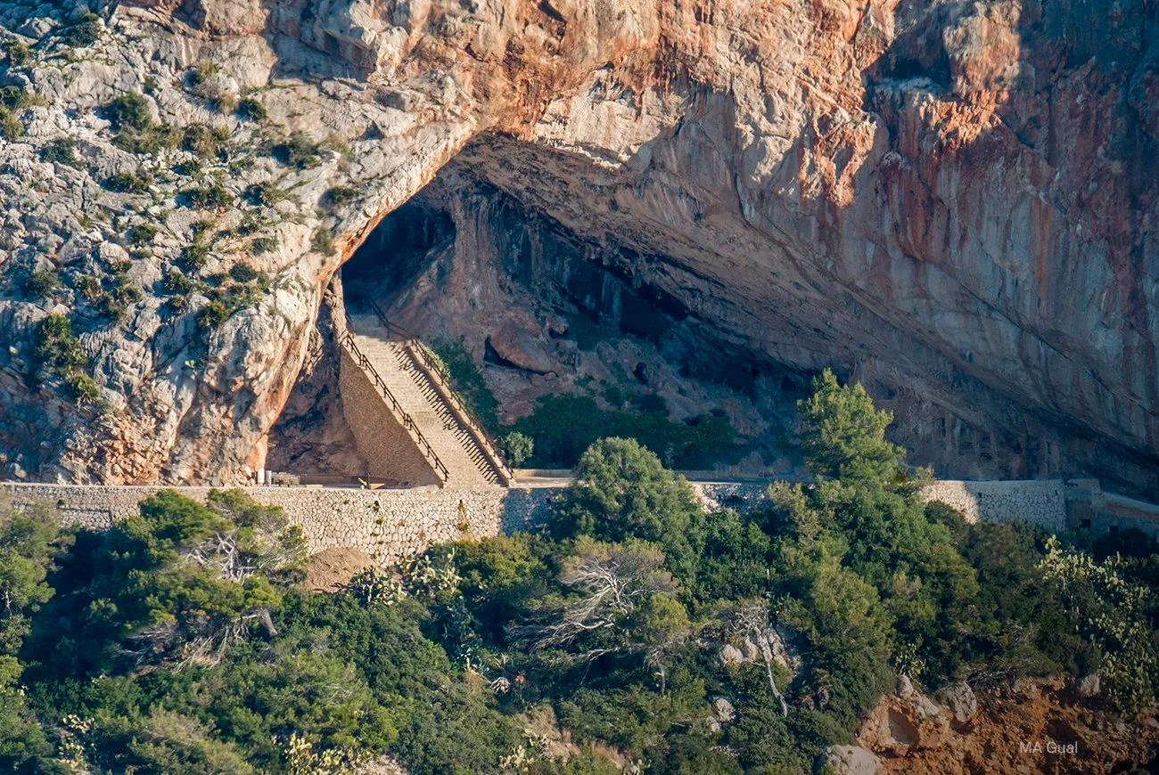 Coves d'Artà cave entrance in cliffs overlooking the Mediterranean — massive stalactite formations, cathedral-like chamber near MALLORCA ART RETREAT