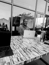 An ADWrap team member smiling while working on a laptop